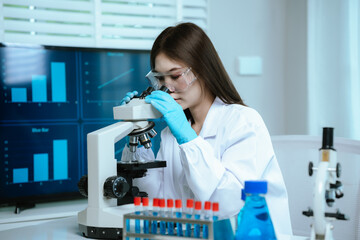 Scientist analyzes biological samples using advanced laboratory equipment for medical research,...