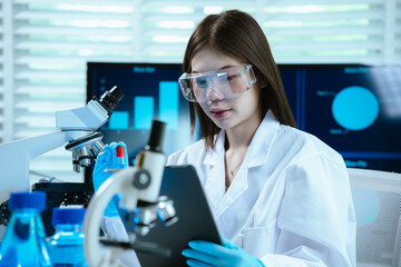 A female scientist works in a sterile laboratory environment, conducting research and experiments...