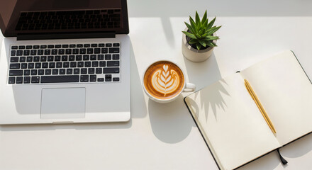 Modern office desk flat lay with laptop computer, coffee cup, and open notebook, top view of clean white workspace with plant