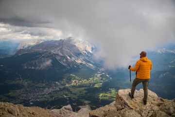 Hiker enjoys the view from Tofana di Mezzo, in the italian Dolomites.