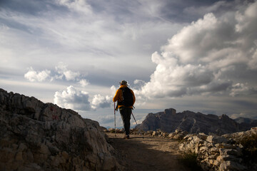 Hiker enjoys the view from Lagazuoi mountain over the italian Dolomites.