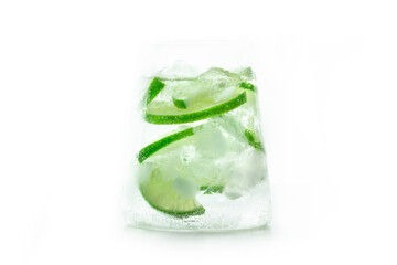 Lime lemonade, or limeade, in a glass with lime and plenty of ice, isolated on a white background