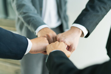 united team raises clenched fists in determination, working together to overcome challenges push forward toward business success and shared goals.