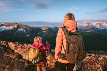 Family hiking in Norway travel together mom and child climbing mountains, parent and daughter...