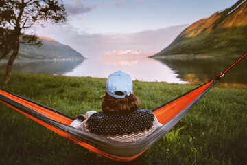 Man relaxing alone in hammock travel lifestyle summer vacations outdoor in Norway, traveler...