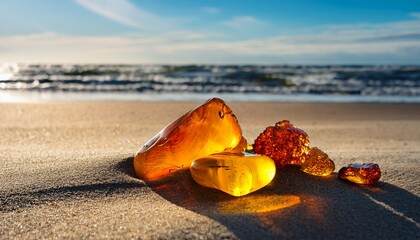 beautiful pieces of amber on the sand beach waves of the baltic sea in the background