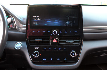 Screen multimedia system on dashboard in a modern electric car. Panel of a premium electric car....