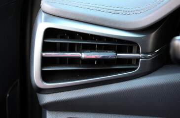 Lux electric car air vents close-up grille. Air ventilation grille with power regulator. Lux electric car air conditioner, interior with front airbag of new premium car. Air ventilation modern vehicle