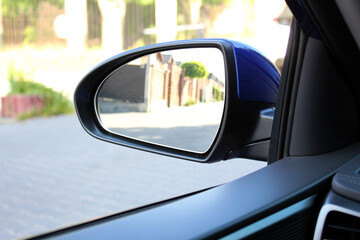 Blue rearview car driving mirror. Side rear-view mirror on a modern car.  Look in the rear view...