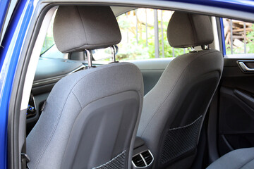 Close-up of the front seat back of a lux car. Front drivers and passenger seat back of textile inside the interior of an expensive luxury sedan. Fabric back passenger seats. 