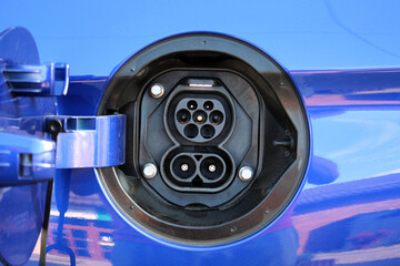 Blue Electric Vehicle Charging Port. Electric vehicle charging port on the rear fender. Electric...