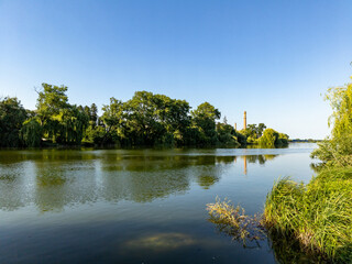 A body of water surrounded by trees and grass