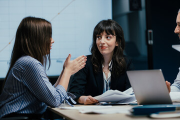 Executive business meeting with performance review on TV screen in luxury office boardroom