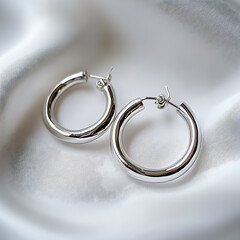 Silver hoop earrings on white background