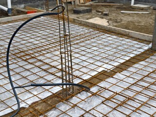 Steel Reinforcement Grid or rebar Installed Over Plastic Sheeting Before Concrete Pour at building construction site