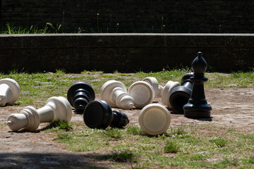 Oversized chess pieces scattered outdoors
