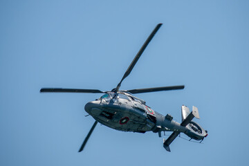 Military helicopter in flight. Naval helicopter flying. Military aircraft, representing aviation...