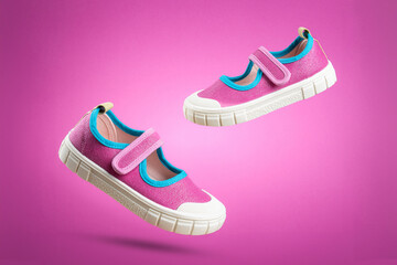 Stylish Pink Kids Sneakers Floating on Pink Background. Fun and Colorful Children's Footwear...