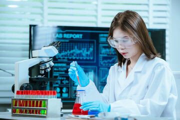 A scientist in a modern laboratory analyzes a blood sample using advanced biotechnology and equipment, conducting medical research for diagnostics, innovation, discovery, and healthcare development.