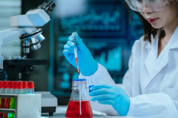 A scientist in a modern laboratory analyzes a blood sample using advanced biotechnology and...