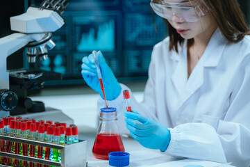 A scientist in a modern laboratory analyzes a blood sample using advanced biotechnology and...