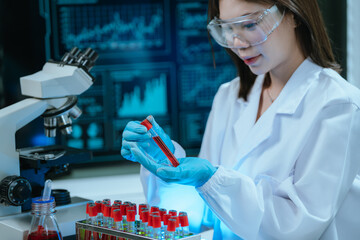 A scientist in a modern laboratory analyzes a blood sample using advanced biotechnology and equipment, conducting medical research for diagnostics, innovation, discovery, and healthcare development.