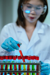 A scientist in a modern laboratory analyzes a blood sample using advanced biotechnology and...