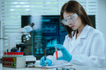 A scientist in a modern laboratory analyzes a blood sample using advanced biotechnology and equipment, conducting medical research for diagnostics, innovation, discovery, and healthcare development.