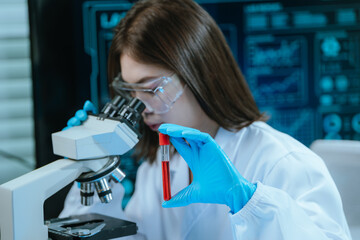 A scientist in a modern laboratory analyzes a blood sample using advanced biotechnology and...