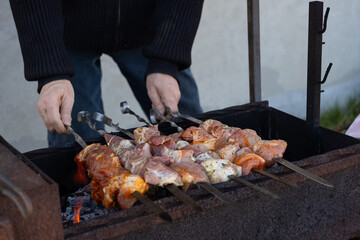 Man Grilling Assorted Marinated Meat Skewers Outdoors