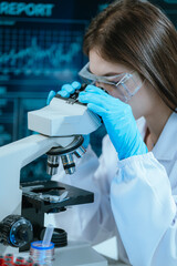 A scientist in a modern laboratory analyzes a blood sample using advanced biotechnology and...