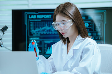 A scientist in a laboratory conducts a medical experiment with a red liquid in a test tube,...