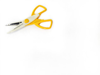 Zigzag wavy pattern scissors on a white background. Yellow creative scissors with serrated blades for decorative cutting. Scissors for crafts, card, scrapbooking and other DIY projects. Free space.