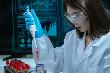 A scientist in a laboratory conducts a medical experiment with a red liquid in a test tube,...
