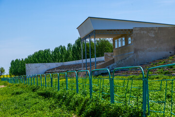 Overgrown wooden bleachers in Kok-Boru stadium in Kyrgyzstan