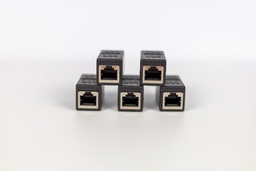 Neatly arranged five black RJ45 Ethernet extender connectors on a clean white background.