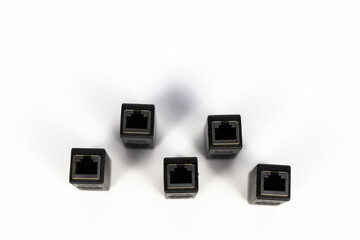 Neatly arranged five black RJ45 Ethernet extender connectors on a clean white background.