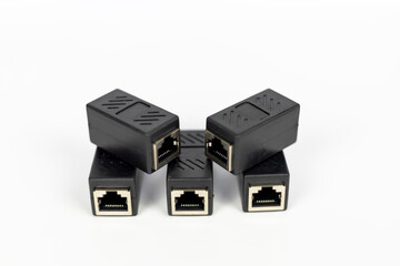Neatly arranged five black RJ45 Ethernet extender connectors on a clean white background.