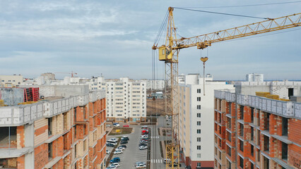 Construction progress in an urban real estate project with a crane and buildings
