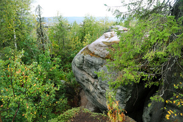 Landscape with rocks and boulders with green trees on a clear sunny day. Flora floristry...