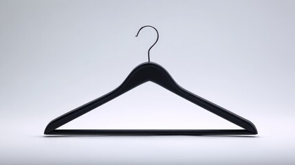 Black clothing hanger suspended against a minimalistic white backdrop, emphasizing simplicity