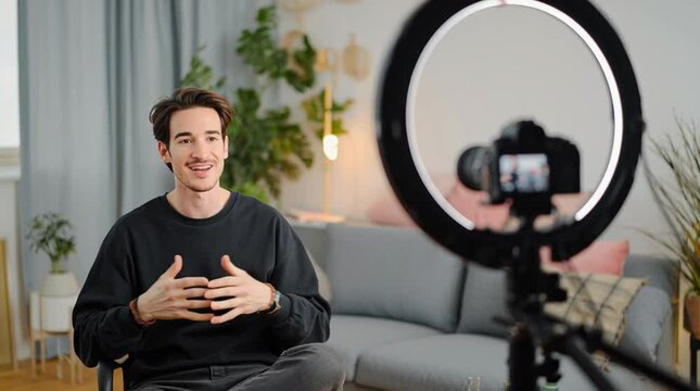 Confident man giving a remote presentation on a video call, with a visible ring light and casual yet professional setup &mdash; ideal for business, online meetings, webinars, and remote-work visuals.
