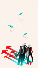 Surreal composite. Happy group of businessman high-fives under three flying paper planes and a...