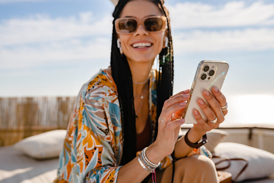 stylish pretty woman with african braids on sunny summer vacation