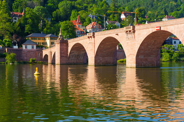 Obraz premium Historic Old Bridge Over the Neckar River and Architecture in Heidelberg Germany