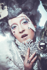 Charming woman in Christmas party costume. Creative makeup, hairstyle, close-up portrait.
