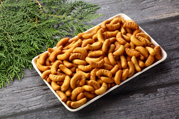Oven fresh cashew biscuits served on a wooden background.