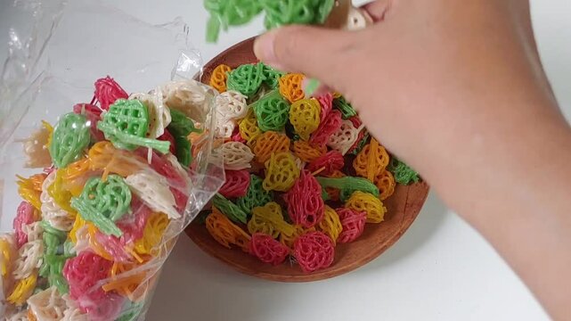 Put the Kerupuk bunga or kerupuk rose or flower cracker or rose cracker to the plastic pack, are typically deep-fried until crispy and are often served as a snack or a side dish in Indonesia.