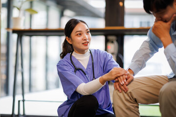 Female nurse hold her man patient's hand. Concept of giving Support. 

