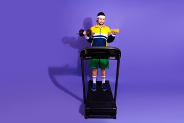 Young man balancing fitness and indulgence on treadmill with vibrant background and contrasting...